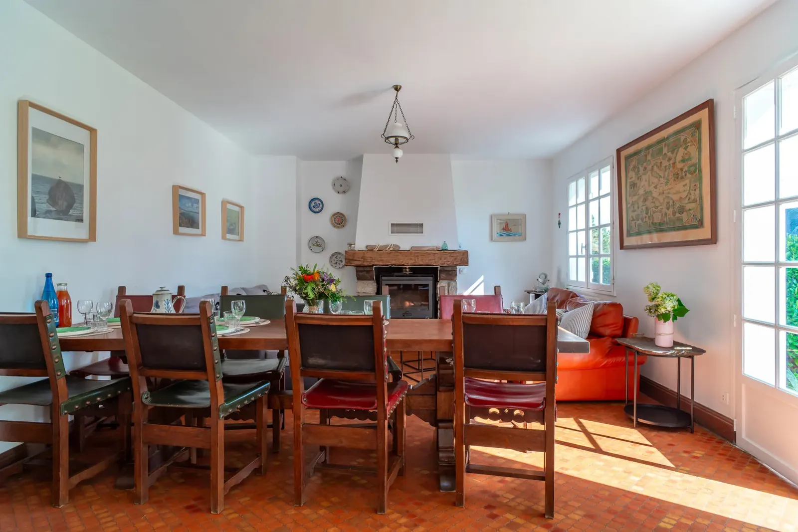 Vue générale de la pièce de vie, de la grande table et de la cheminée